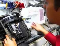 Vacuum repair technician servicing internal components on a workbench in Nashville, TN